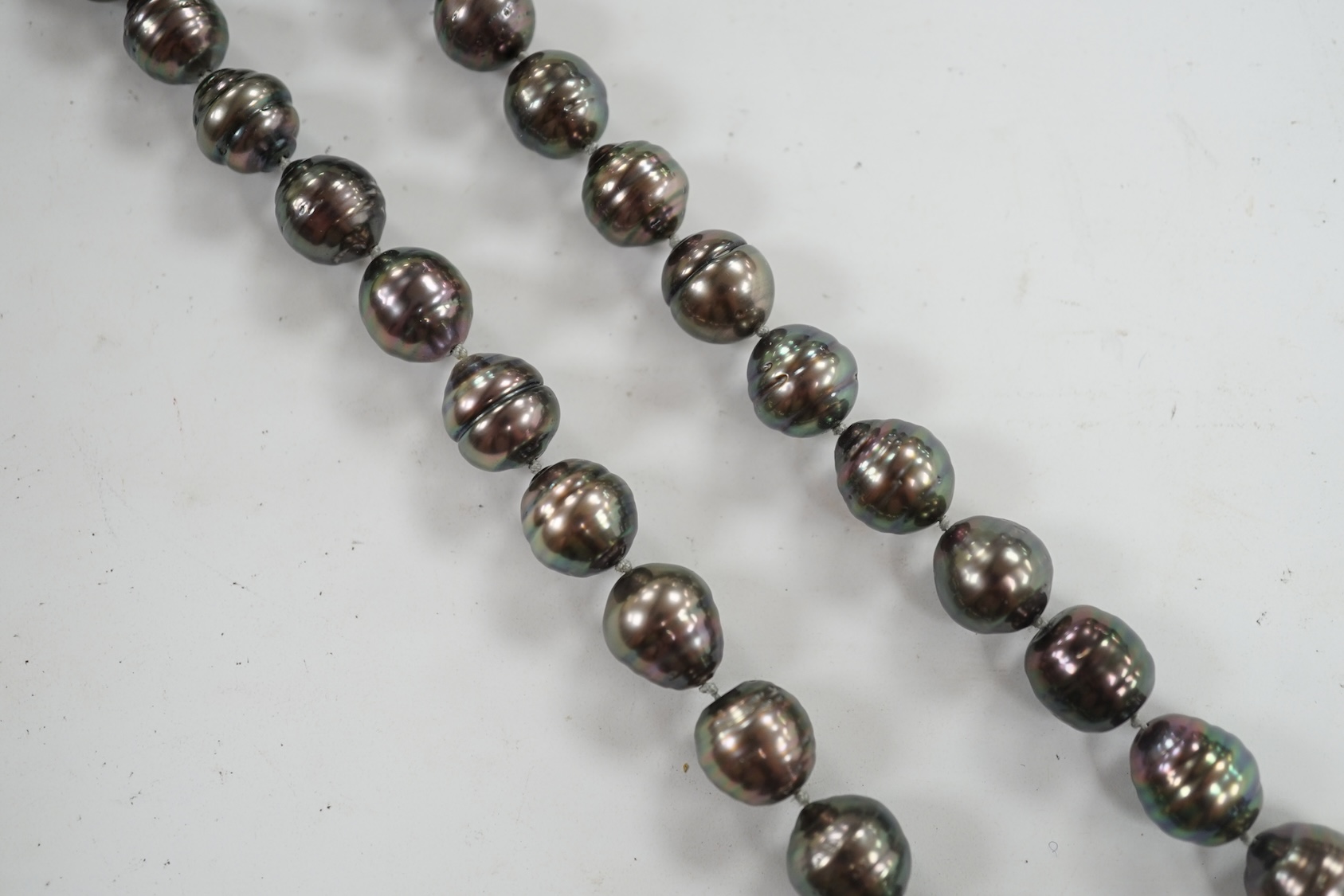 A modern single strand graduated Tahitian baroque cultured pearl necklace, with cabochon set yellow metal clasp, 48cm. Condition - fair to good